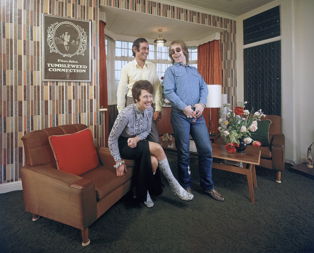 Rock musician Elton John (R) sharing a laugh w. his mother Shelia (L) and stepfather Fred Fairebrother (C) in their apartment.