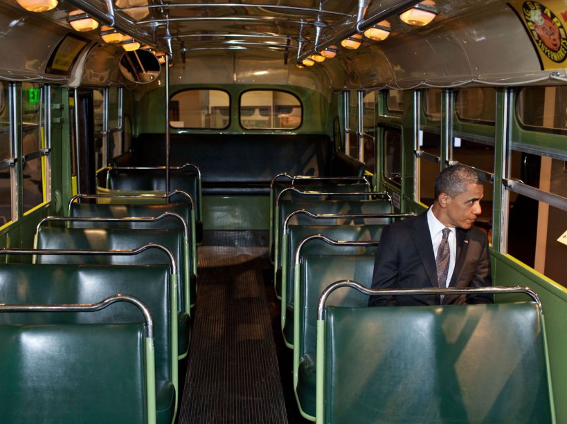 President Barack Obama sits on the famed Rosa Parks bus at the Henry Ford Museum following an event in Dearborn, Michigan, April 18, 2012. (Official White House Photo by Pete Souza) This official White House photograph is being made available only for publication by news organizations and/or for personal use printing by the subject(s) of the photograph. The photograph may not be manipulated in any way and may not be used in commercial or political materials, advertisements, emails, products, promotions that in any way suggests approval or endorsement of the President, the First Family, or the White House.Ê