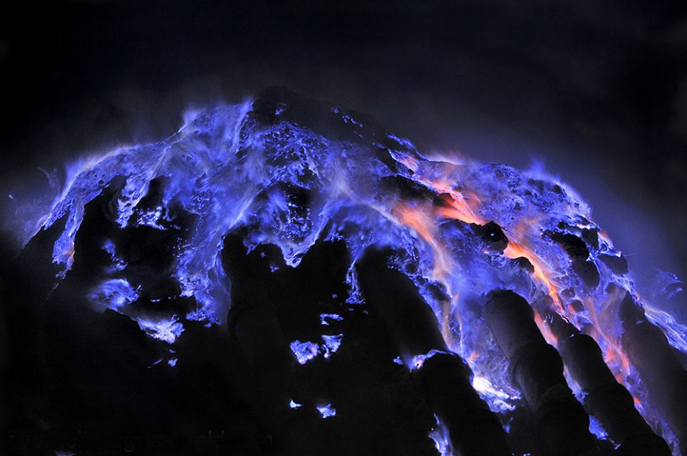 Escaped at gaseous state from the Kawah Ijen crater on Java Island in Indonesia sulfur combusts on contact with air, liquefies and run in impressive rivers of blue flames. Indon  sie