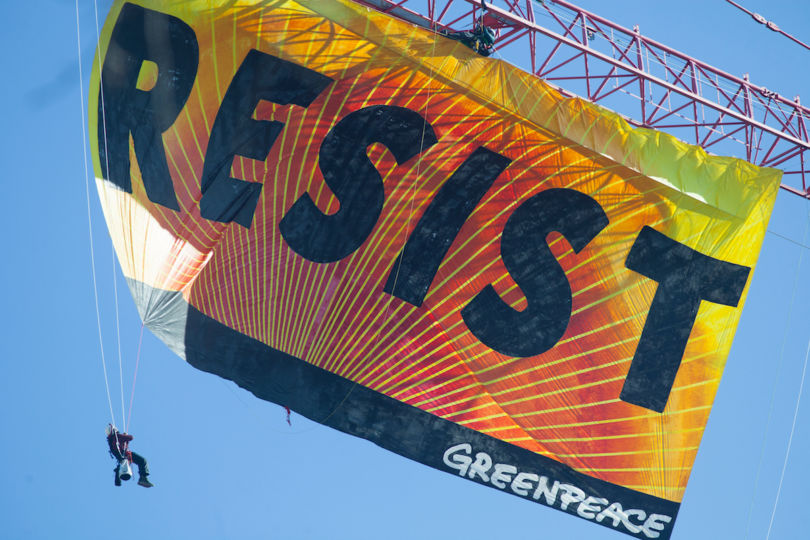 Greenpeace activists deploy a banner on a construction crane near the White House reading "RESIST" on President Trump's fifth day in office.The activists are calling for those who want to resist Trump's attacks on environmental, social, economic and educational justice to contribute to a better America.